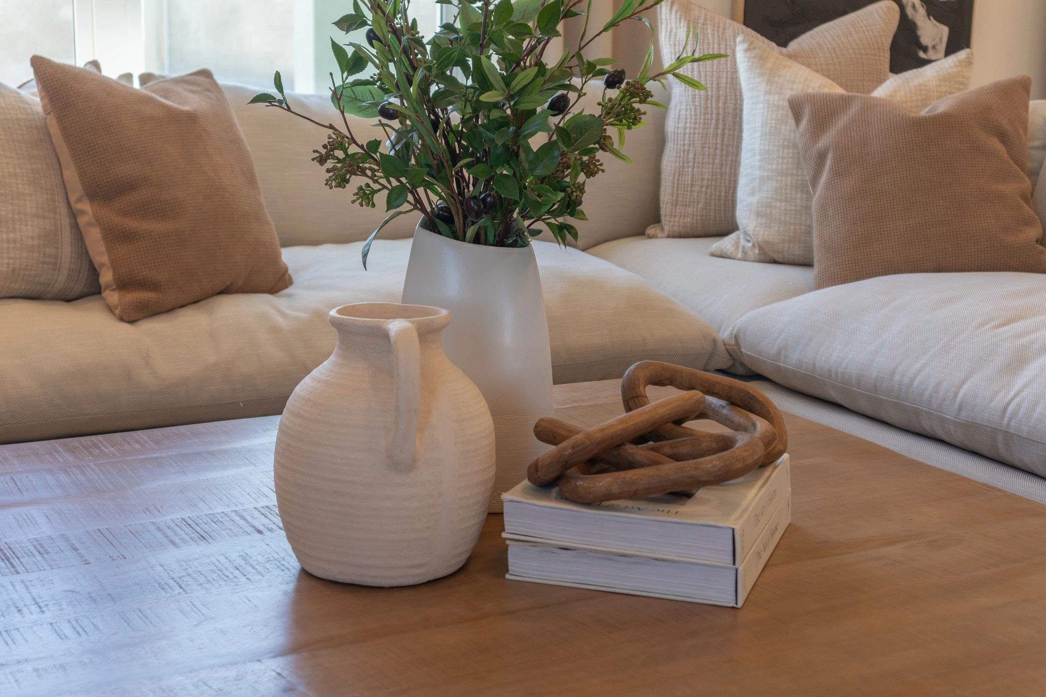 Wood coffee table styled in a modern living room