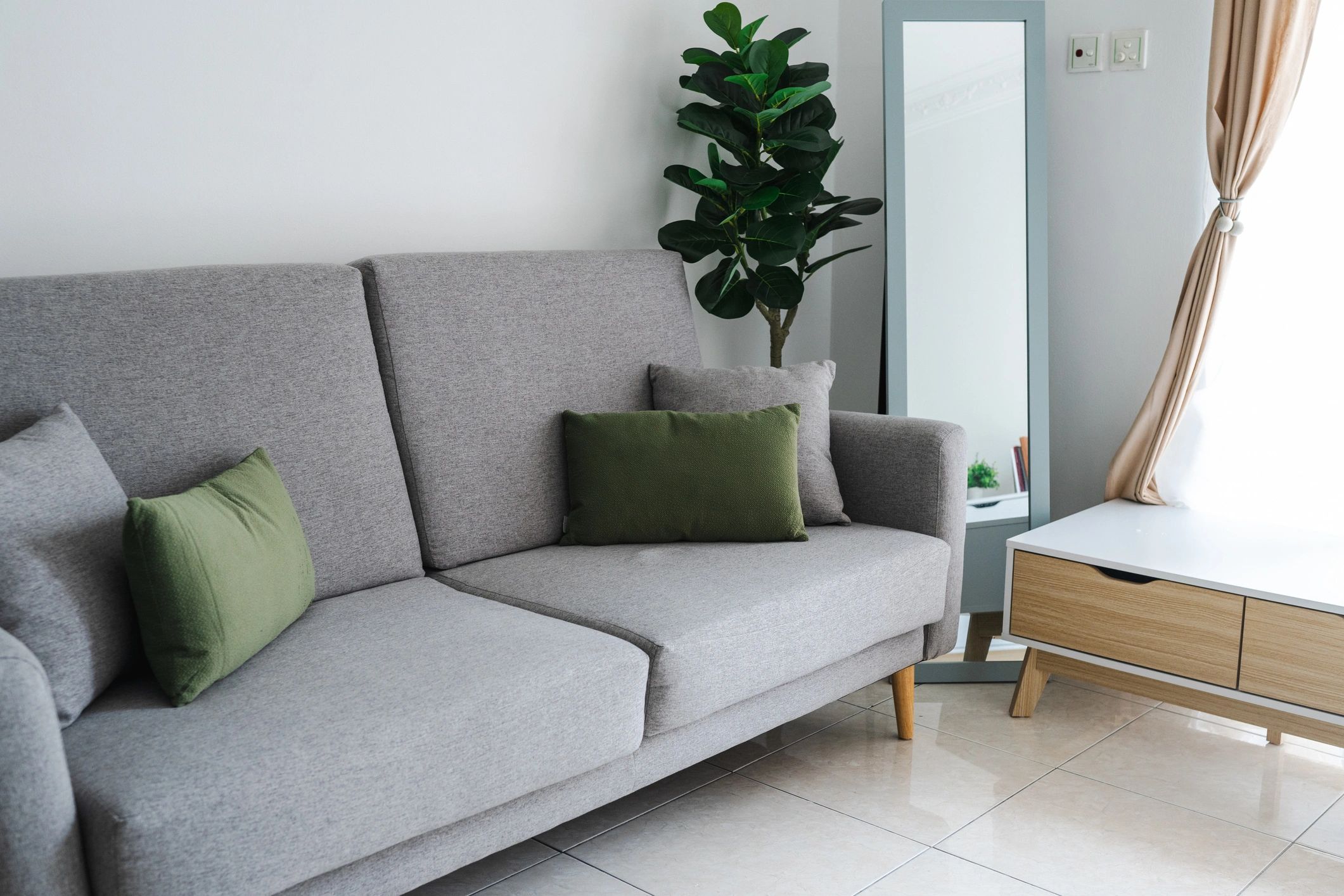 Minimal living room with grey sofa and modern furniture