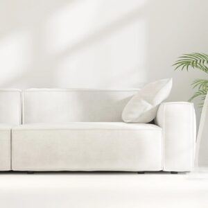 Minimal, luxury living room with white sofa, plant, in sunlight through fluttering sheer curtain window on floor